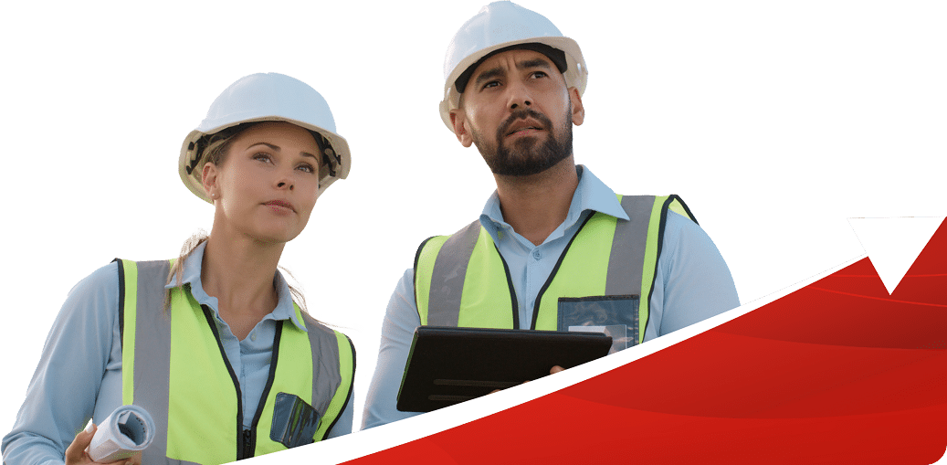 man and women in hard hats and reflective vests looking off toward something.